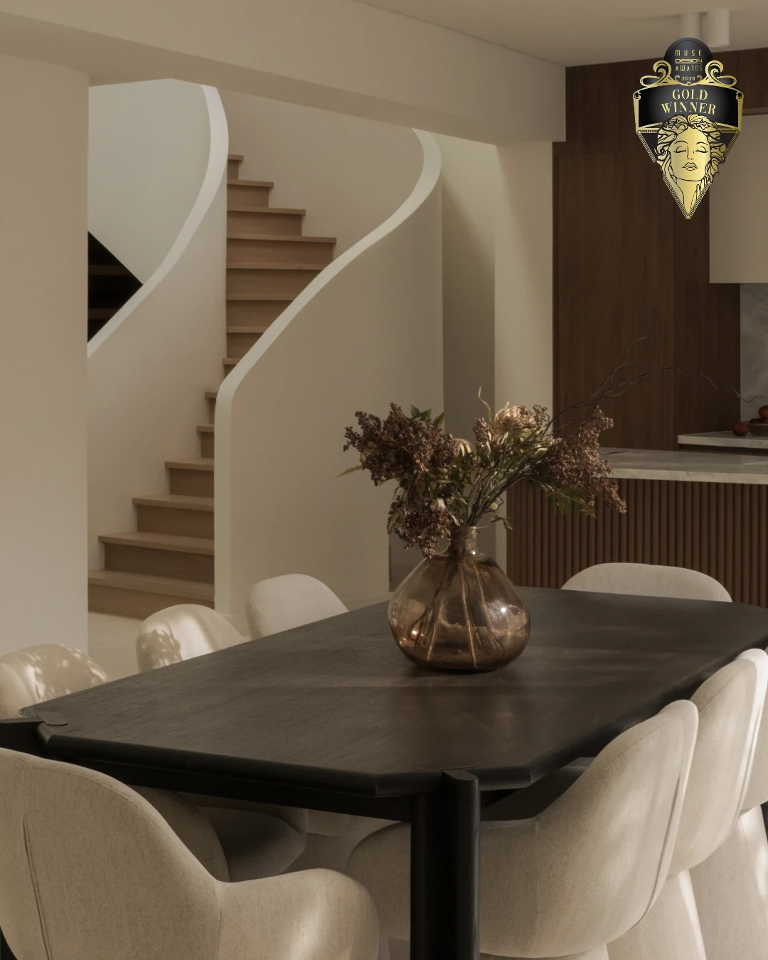 Elia House dining area beside the sculptural staircase
